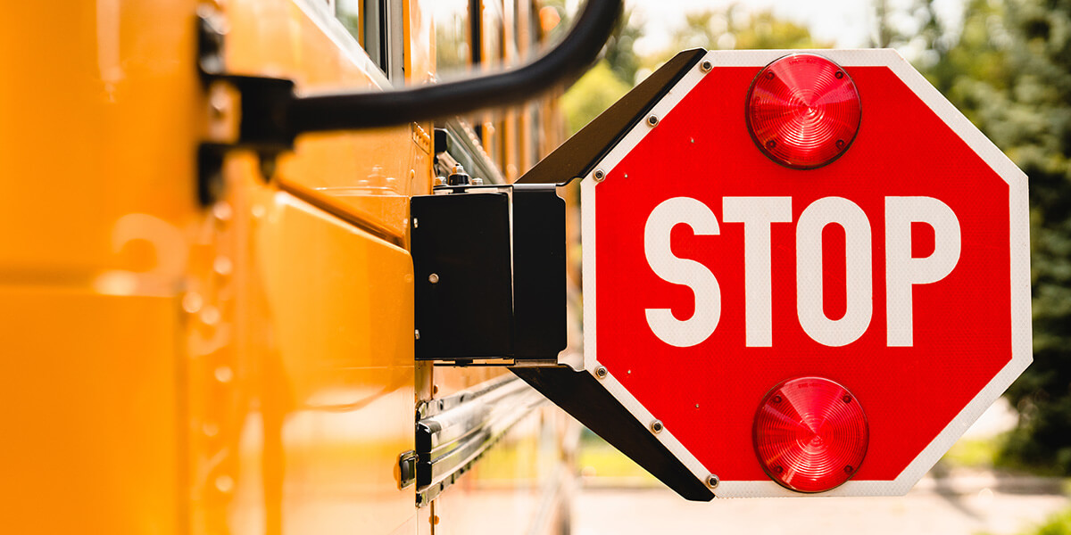 repaired school bus crossing stop sign and safety lights