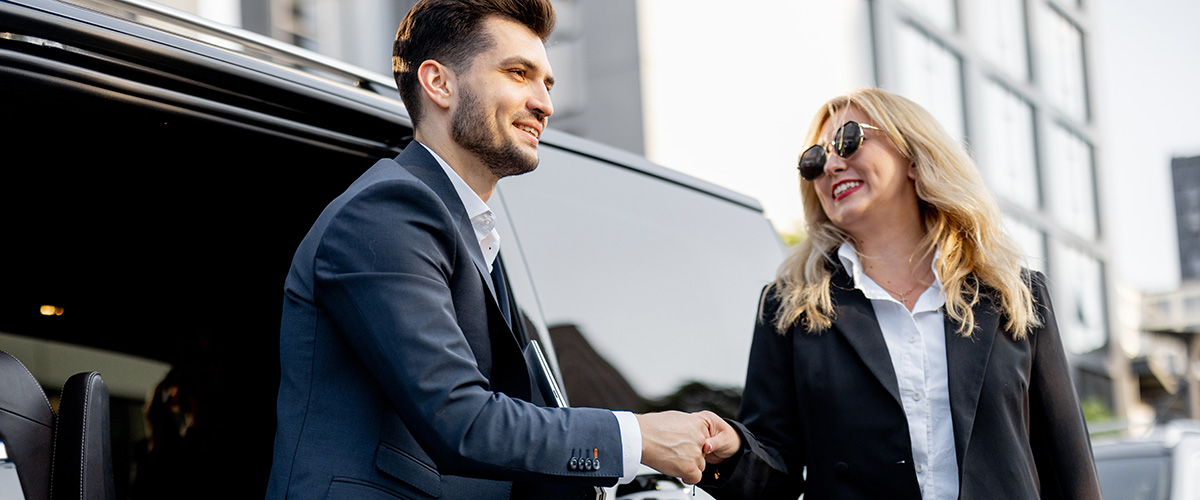 Corporate VIP exiting a commercial van at event near downtown Denver, CO