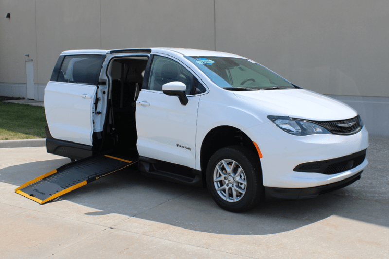 White Chrysler Voyager wheelchair minivan with wheelchair ramp extended