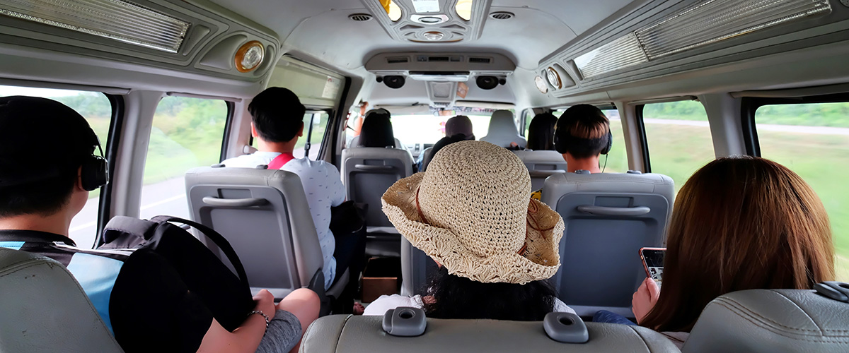 Passenger exploring Los Angeles inside a shuttle bus rental