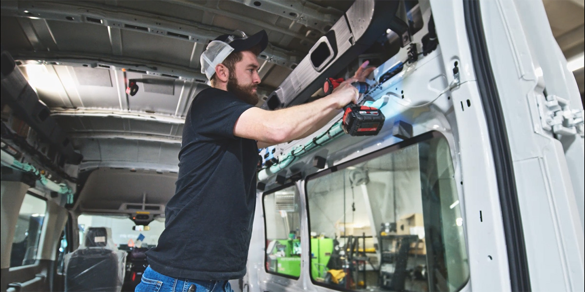 maintenance technician repairing van